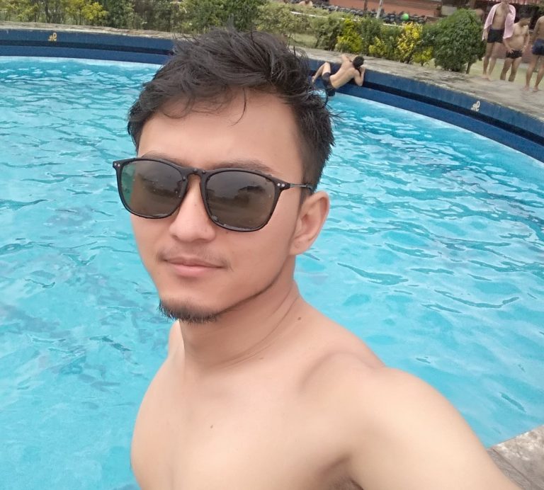 Nepali boy Wilson Shrestha taking selfie on swimming pool wearing black sunglass 