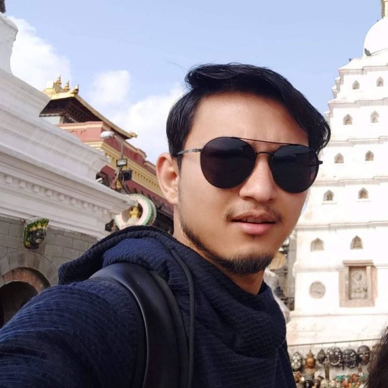Wilson Shrestha taking selfie on Syambhunath Nepal, Nepali Boy with black glass shades taking picture with mobile phone